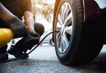 A mechanic inspecting for car tires maintenance.
