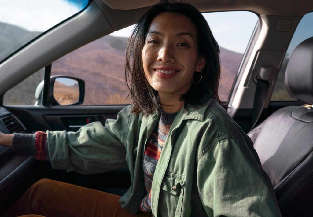 Indonesian woman reviewing car purchase options with a salesperson