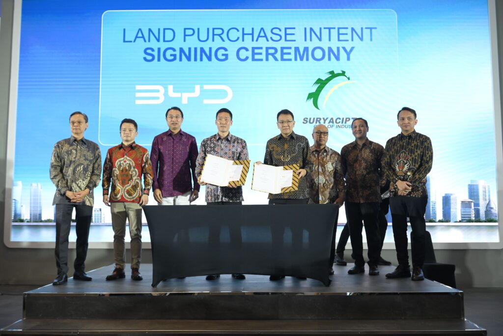 BYD and PT Suryacipta Swadaya executives posing with signed documents at the land purchase intent signing ceremony.