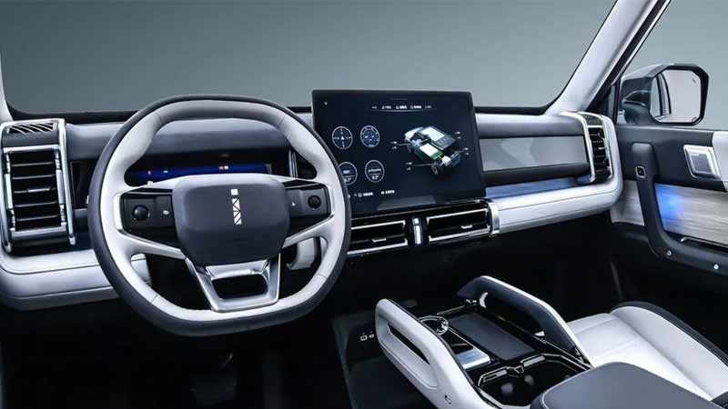 Interior of iCar-03 with a white and black dashboard, a large central touchscreen, and a white steering wheel with silver accents.