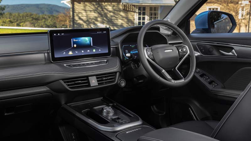 Interior of a Haval Jolion SUV with a black dashboard, leather seats, and a large central touchscreen.