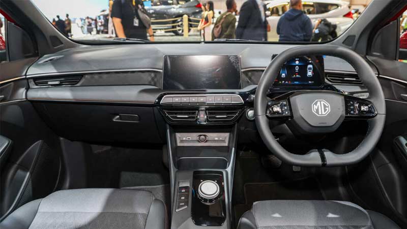 Interior view of a car showcasing the MG3 dashboard, steering wheel, and large central touchscreen display.