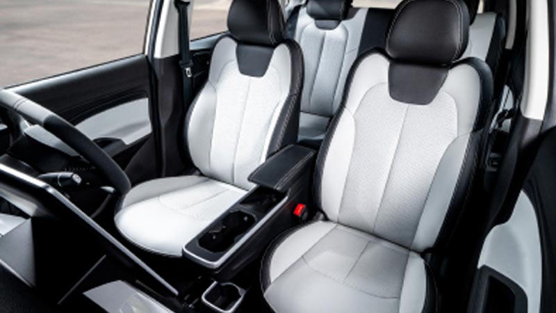 Interior seats of the NETA V-II, showcasing comfortable white and black upholstery.