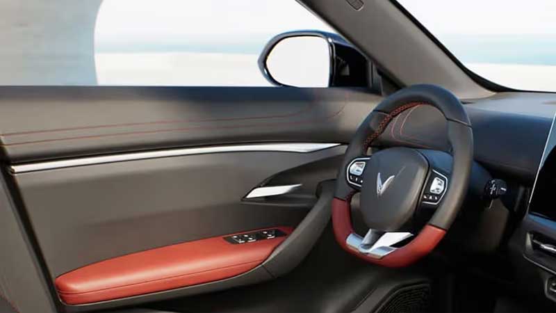 Interior view of the driver's side and door panel in a VinFast VF 7 electric SUV