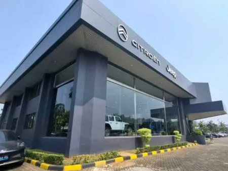 Jeep dealership in PIK Jakarta showroom exterior with Jeep vehicles on display - autoini